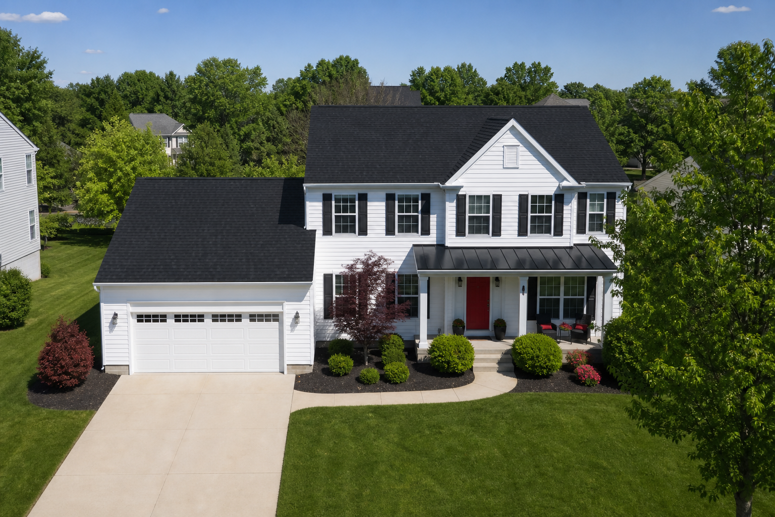 Drone view of a completed black shingle roof and white home exterior
